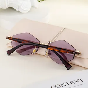 Detail of rimless geometric sunglasses with purple gradient lenses and cream leather case