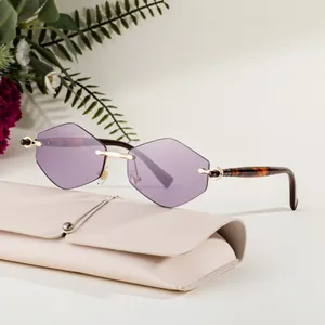 Frameless geometric sunglasses with purple lenses, gold temples, and a beige leather pouch