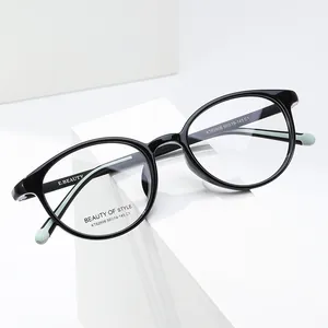 Oval full-rim black optical glasses frames with mint green tips on white display stand