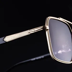 Detail of gold metal hinge with vertical stripe embossing on square sunglasses
