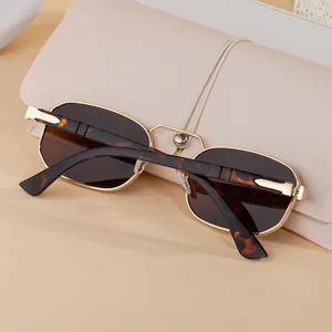Detail of vintage square metal sunglasses with tortoiseshell arms and beige leather pouch