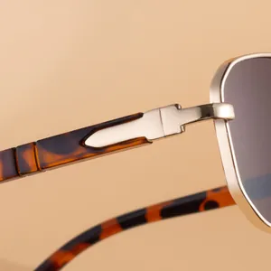 Macro shot of gold metal hinges and dark brown tortoiseshell temples on retro sunglasses