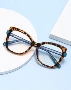 Detail of leopard print cat-eye frame glasses with blue light lenses on blue background
