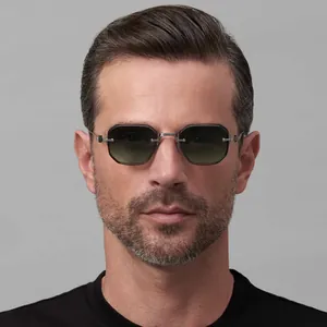 Macro detail of men's octagonal rimless sunglasses with gradient green lenses and silver parts