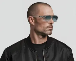 Side view of square sunglasses with transparent frames and blue gradient lenses on model