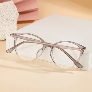 Detailed macro view of gray gradient cat-eye frame with slender gold metal temples