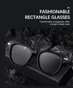 Detail of polygonal sunglasses with golden hinge accents on black leather and stone