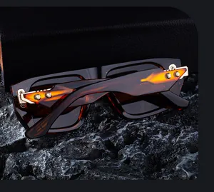 Macro detail of tortoiseshell sunglasses frame with industrial metal hinge components