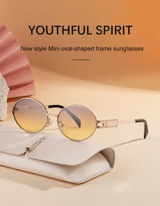 Detail of vintage oval metal sunglasses with engraved gold frame and gradient lenses