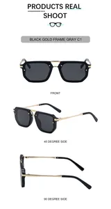 Detail view of square black and gold frame sunglasses with metal double bridge and grey lenses