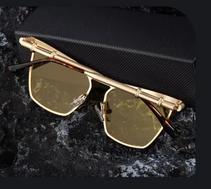 Detail of gold metal cat-eye sunglasses with yellow lenses and dark textured case