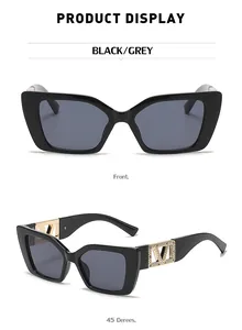 Detail of square cat-eye sunglasses with golden V logo and rhinestone accents