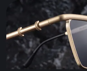 Detail of premium golden metal hinges and ring-shaped temple design on cat-eye sunglasses
