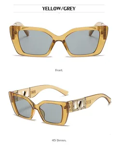 Detail of yellow cat eye sunglasses with gold rhinestone V accents and grey lenses
