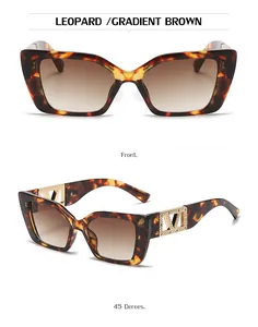 Detail of leopard print cat-eye sunglasses with golden V-shaped rhinestone metal temples