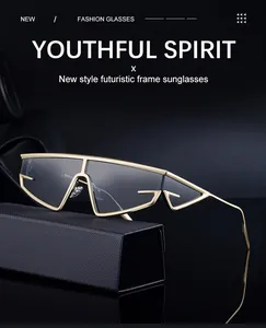 Close-up of futuristic golden metal sunglasses with hollow geometric frame and dark lenses