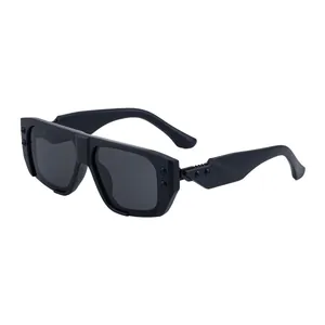 Modern square black sunglasses with thick frames and stylish metal rivets on white background