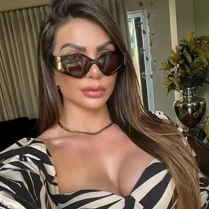 Close-up of stylish tortoise sunglasses with square gold metal accents on female model