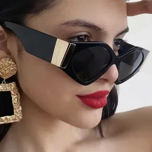 Fashionable black cat-eye sunglasses with gold metal temples and gray polarized lenses