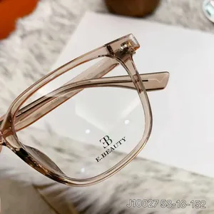 Detail view of transparent tea TR90 eyeglass frame with specs J10027 53-18-152