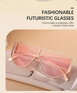 Detail of oversized futuristic sunglasses with pink lenses and gold frame and case