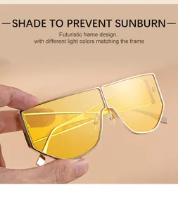 Detail of futuristic gold metal frame sunglasses with one-piece yellow lens