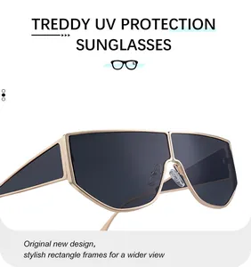Detail view of gold metal irregular sunglasses with UV protection and large dark lenses