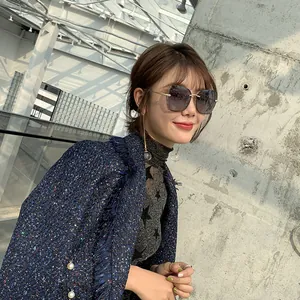 Close-up of trendy rimless polarized sunglasses with gradient lenses on a fashion model