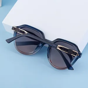 Close-up of blue translucent frame sunglasses with detailed gold hollow metal temple hinges
