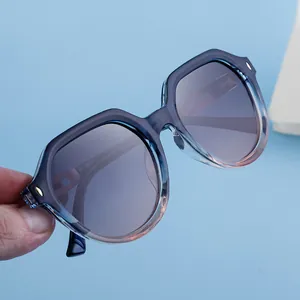 Detail view of blue gradient square polarized sunglasses with golden metallic rivet accents