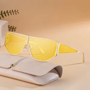 Irregular punk sunglasses with yellow lenses and silver frame on a beige leather pouch