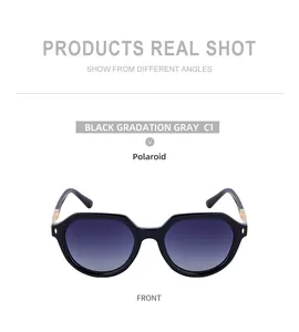 Detail of square black polarized sunglasses with gold metal hinges and gradient lenses
