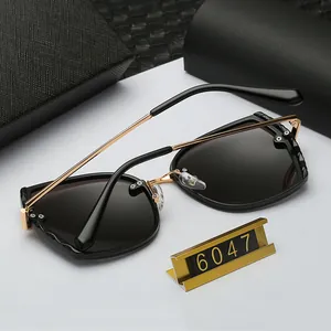 Detail view of model 6047 polarized sunglasses with gold temples and wavy embossed frames