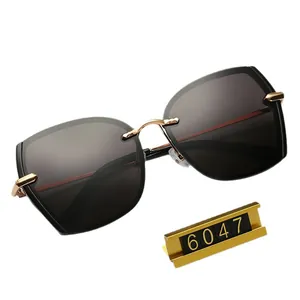 Frameless polarized sunglasses for women with black gradient lenses and gold bridge