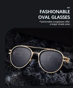 Detail view of oval sunglasses with golden metal double bridge and dark lenses on a black rock