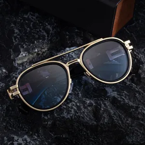Steampunk oval sunglasses with gold metal frame and double bridge on dark stone