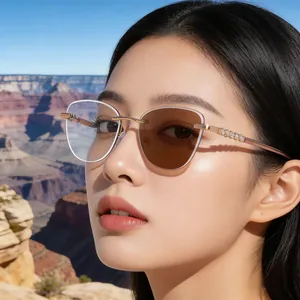 Cat-eye rimless photochromic sunglasses with gold temples and color-changing lens contrast