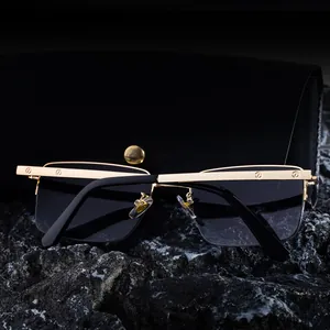 Detail of square gold metal sunglasses bridge with screw accents on stone base