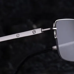Macro detail of silver metal glasses frame showing screw decor on polished temples