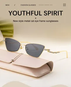 Detail of cat eye sunglasses with gold metal frame and rhinestone temple accents