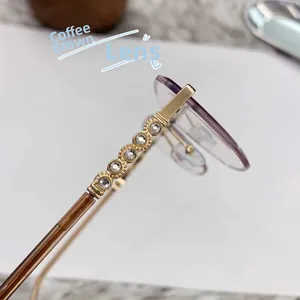 Close-up of golden rhinestone temples and thickened purple lenses on cat-eye sunglasses