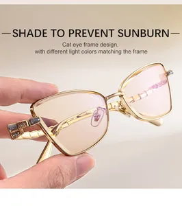 Close-up of cat-eye sunglasses with gold metal frame and gray geometric crystal detail