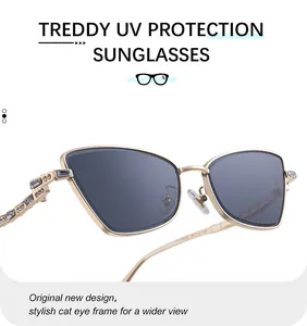 Detailed view of cat-eye sunglasses with luxury rhinestone crystals on golden metal frames