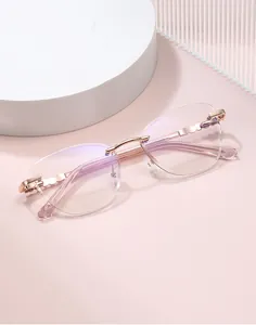Detail of rimless cat-eye sunglasses with rose gold wavy metal temples and purple lenses