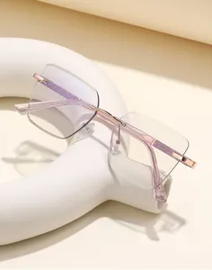 Detail of rose gold rimless square glasses with purple glitter temples on white props