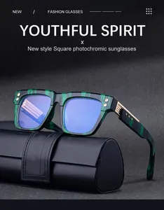 Close-up of square photochromic sunglasses with green marble frame and blue lenses
