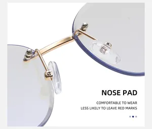 Close-up of golden metal bridge and soft silicone nose pads on rimless cat-eye sunglasses