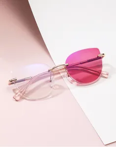 Detailed macro view of rimless cat-eye sunglasses with purple glitter on gold temples