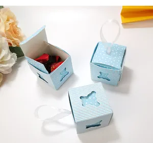 Macro view of blue bear hollow candy gift box with ribbon handle and stripe heart pattern