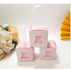 Detailed view of pink striped mini gift boxes with cute hollow bear design and silk handles